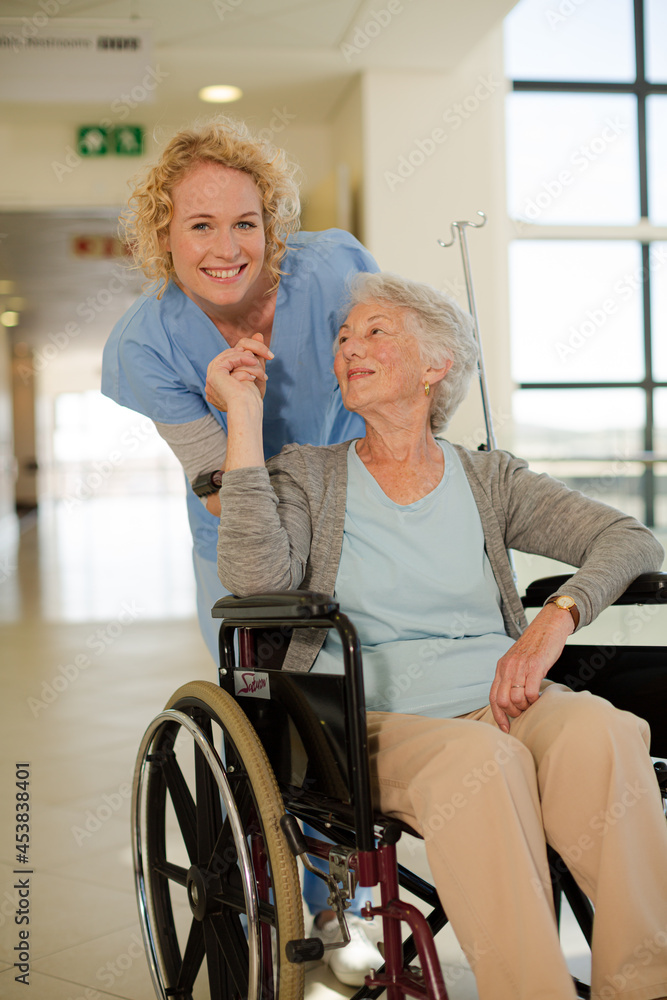 Portrait of smiling nurse and elderly patient in wheelchair Portrait of smiling nurse and elderly patient in wheelchair
