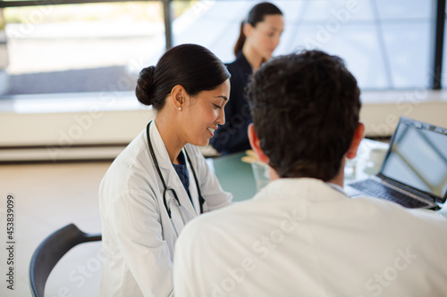 Doctors and businesswoman talking in meeting