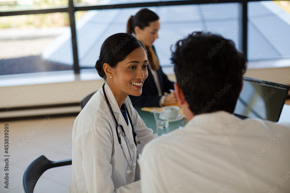 Doctors and businesswoman talking in meeting