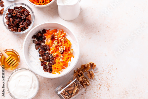 Fototapeta Naklejka Na Ścianę i Meble -  Carrot and raisins overnight oats with walnuts, high protein healthy breakfast