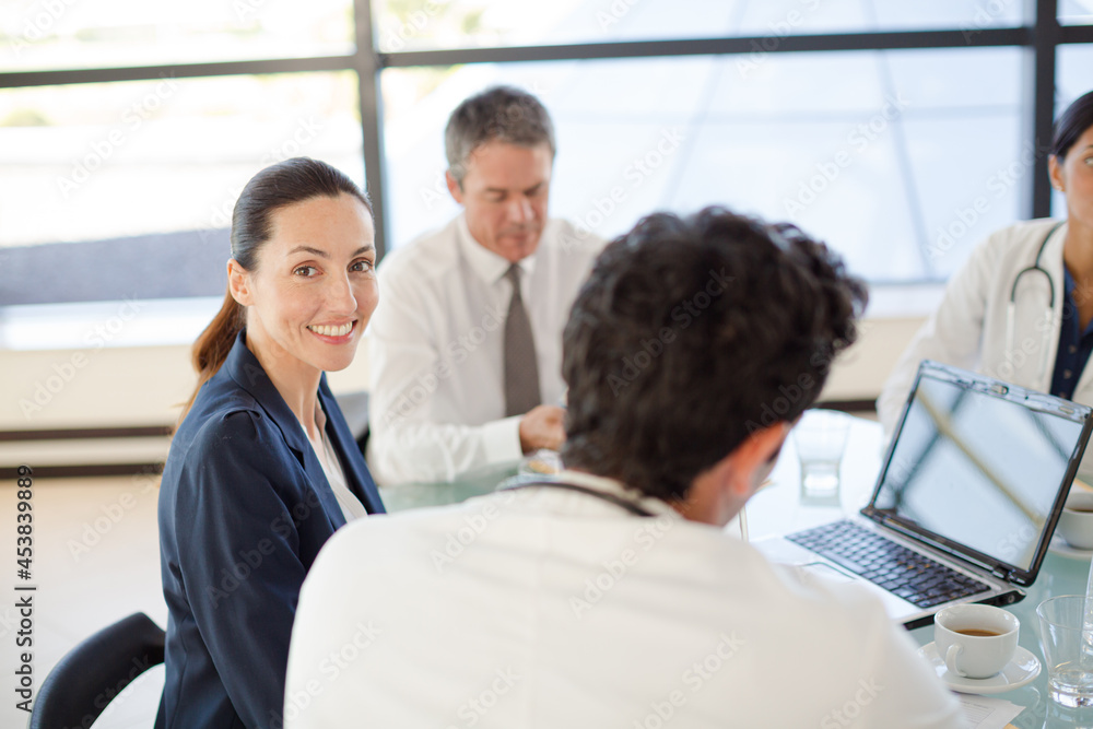 Doctors and businesswoman talking in meeting Doctors and businesswoman talking in meeting