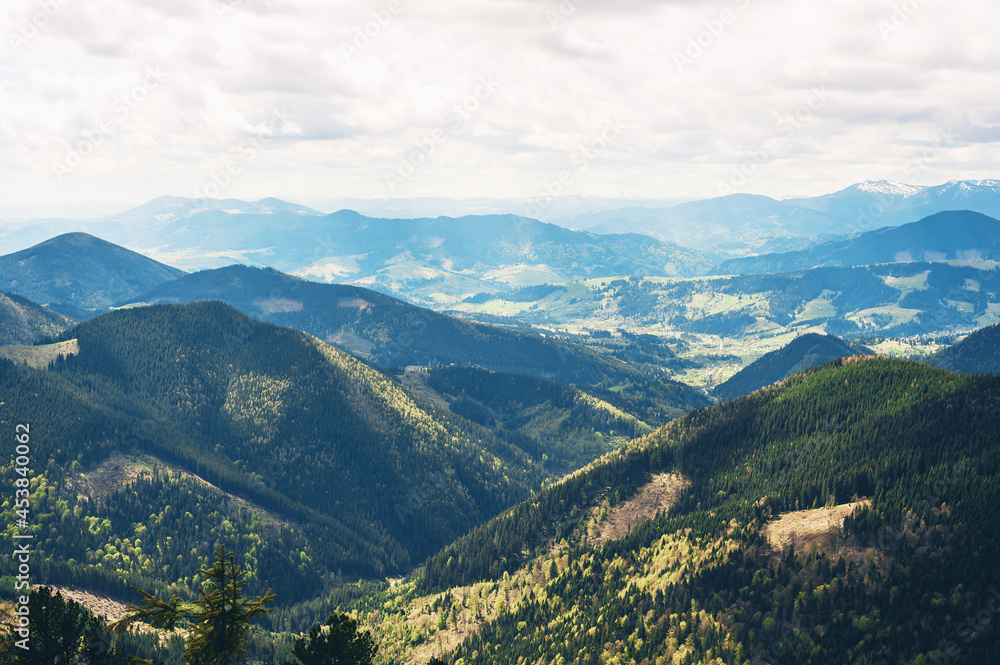 Beautiful view with alpine valley in the background.fluffy clouds on a blue sky above the distant ridge. mountainous countryside scenery. dramatic sky above the distant valley. Beautiful view with alpine valley in the background.fluffy clouds on a blue sky above the distant ridge. mountainous countryside scenery. dramatic sky above the distant valley.
