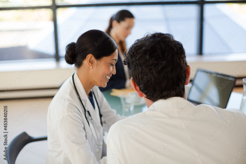 Doctors and businesswoman talking in meeting Doctors and businesswoman talking in meeting