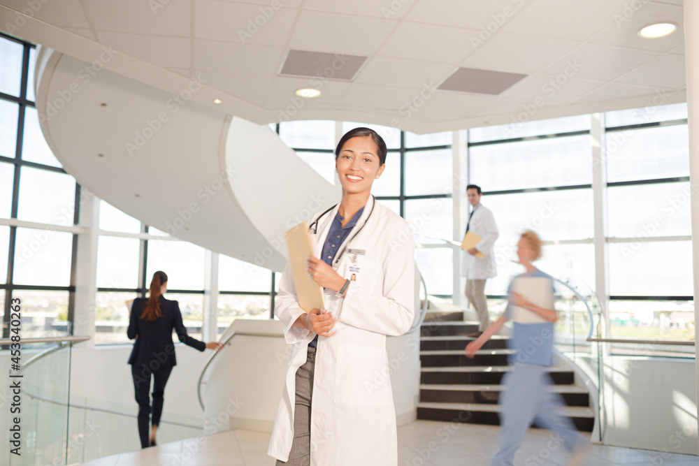 Portrait of smiling doctor in hospital atrium Portrait of smiling doctor in hospital atrium