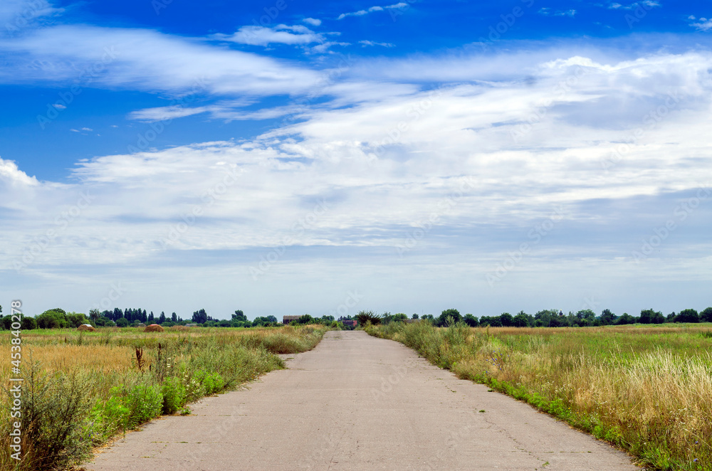 road in the countryside with blue sky on the horizon road in the countryside with blue sky on the horizon