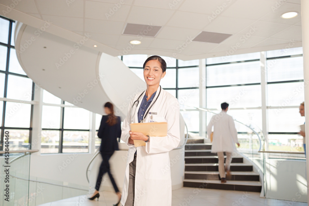 Portrait of smiling doctor in hospital atrium Portrait of smiling doctor in hospital atrium