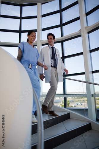Doctor and nurse talking on staircase