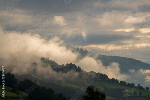 autumnal atmosphere on the mountains at the mornig with fog and sunslight