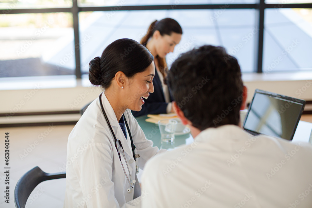 Doctors and businesswoman talking in meeting Doctors and businesswoman talking in meeting