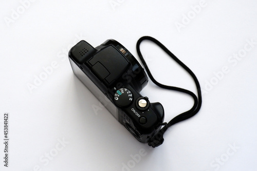 Obsolete digital compact camera on white background