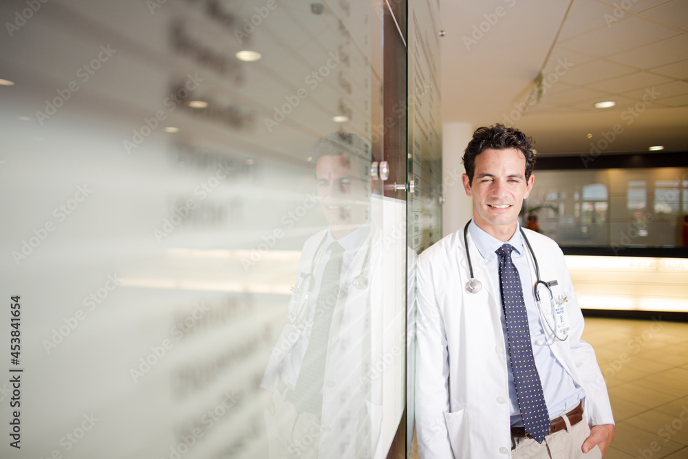Portrait of smiling doctor in hospital corridor