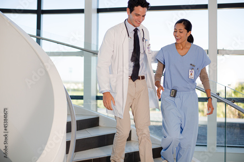 Doctor and nurse talking on staircase