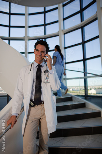 Doctor talking on cell phone in hospital © KOTO