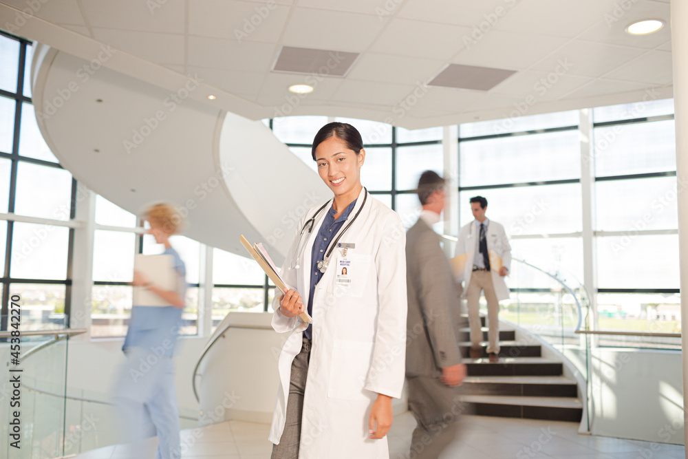 Portrait of smiling doctor in hospital atrium Portrait of smiling doctor in hospital atrium