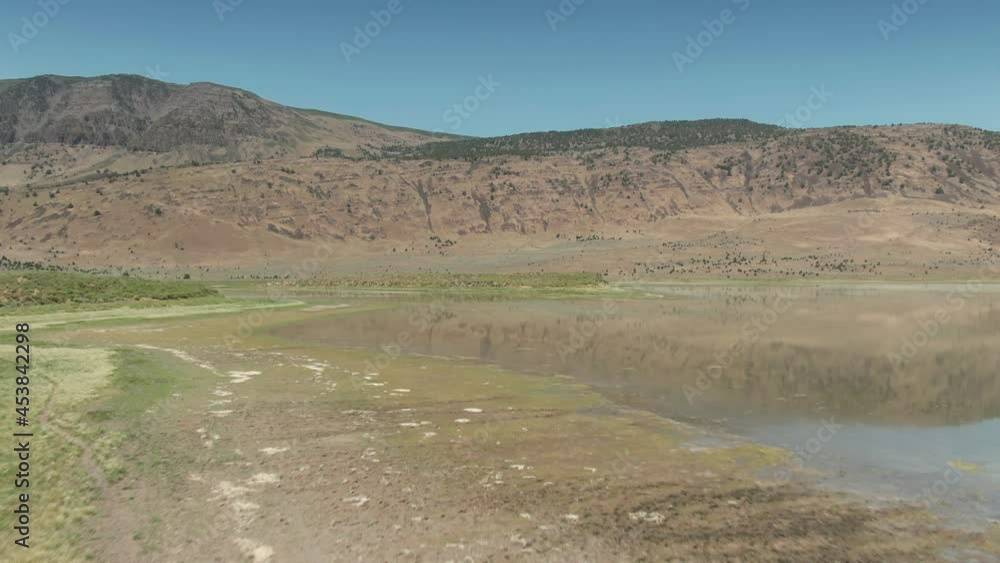 Aerial: Juniper Lake, a reflective lake in the Dessert, Steens Mountain Wilderness, Oregon, USA Aerial: Juniper Lake, a reflective lake in the Dessert, Steens Mountain Wilderness, Oregon, USA