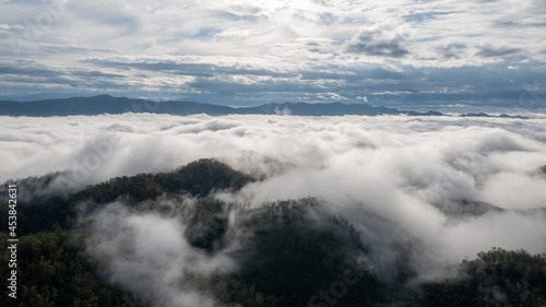 aerial view of clouds on beautiful mountains beautiful nature that covers the fertile tropical forests of Nan Province Northern Thailand, Ya Luang Suan © PIPAT