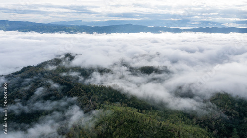 aerial view of clouds on beautiful mountains beautiful nature that covers the fertile tropical forests of Nan Province Northern Thailand, Ya Luang Suan © PIPAT