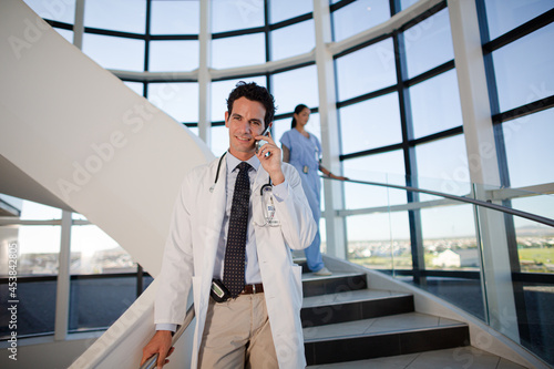 Doctor talking on cell phone in hospital