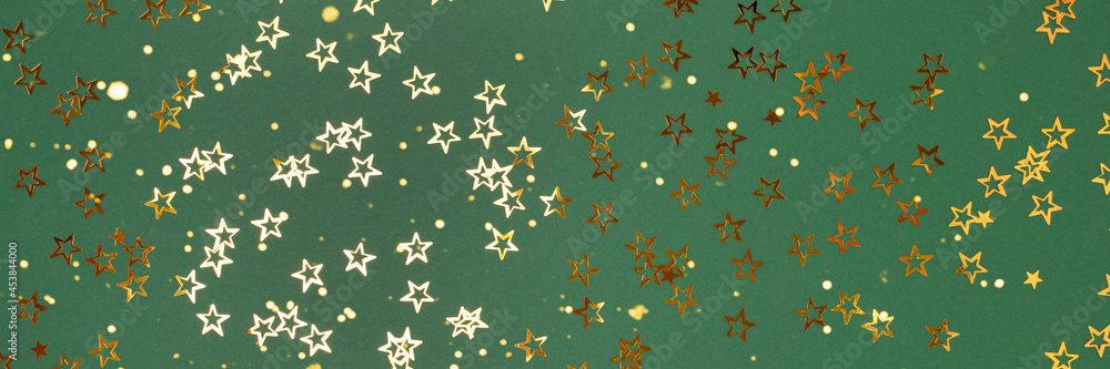 Banner with trendy gold stars confetti on a green background. Banner with trendy gold stars confetti on a green background.