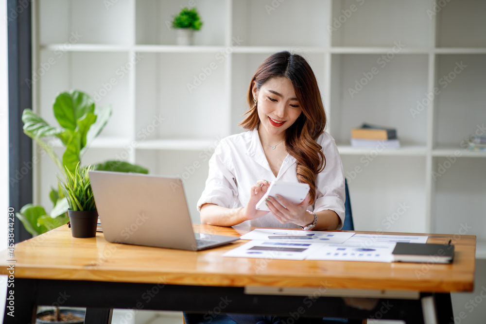 Portrait of smiling beautiful business asian woman with working in modern office desk using computer, Business people employee freelance online marketing e-commerce telemarketing concept. Portrait of smiling beautiful business asian woman with working in modern office desk using computer, Business people employee freelance online marketing e-commerce telemarketing concept.