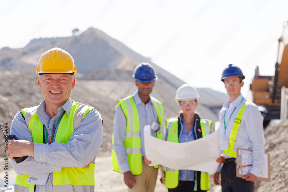 Business people and workers talking in quarry Business people and workers talking in quarry