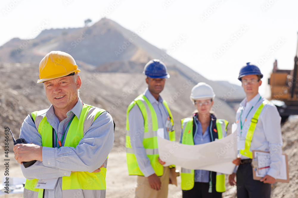 Business people and workers talking in quarry Business people and workers talking in quarry