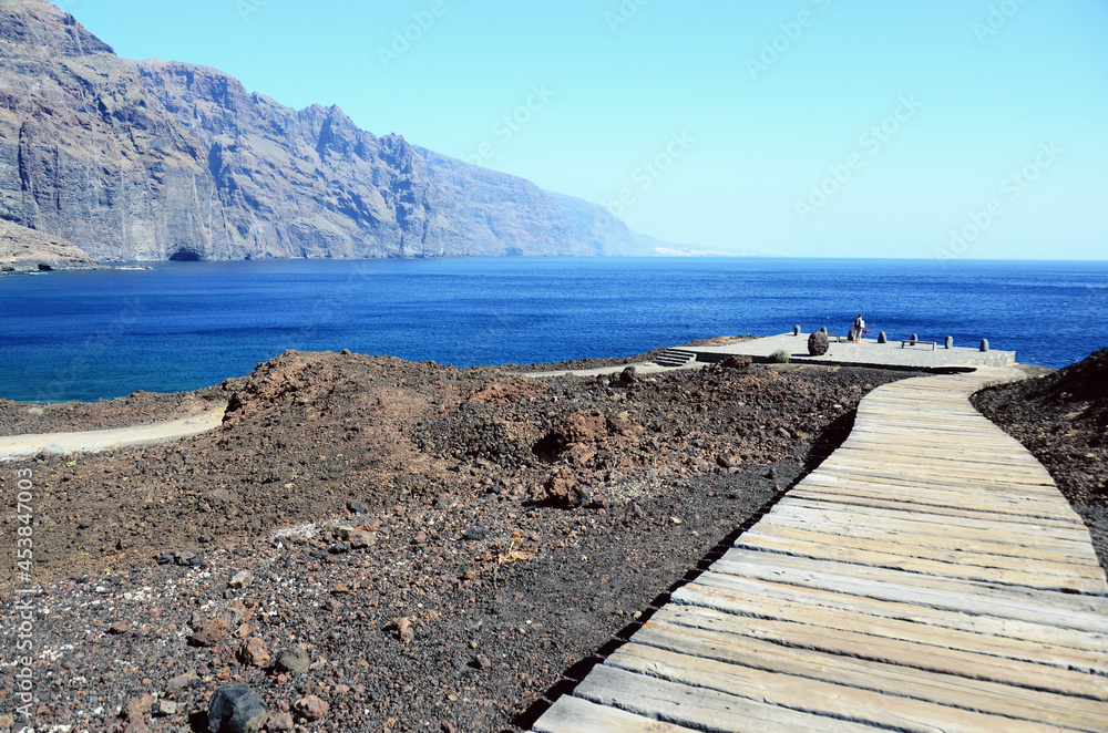 TENERIFE, SPAIN: Scenic seashore view of Los Gigantes ancient rocks with blue sea waters TENERIFE, SPAIN: Scenic seashore view of Los Gigantes ancient rocks with blue sea waters