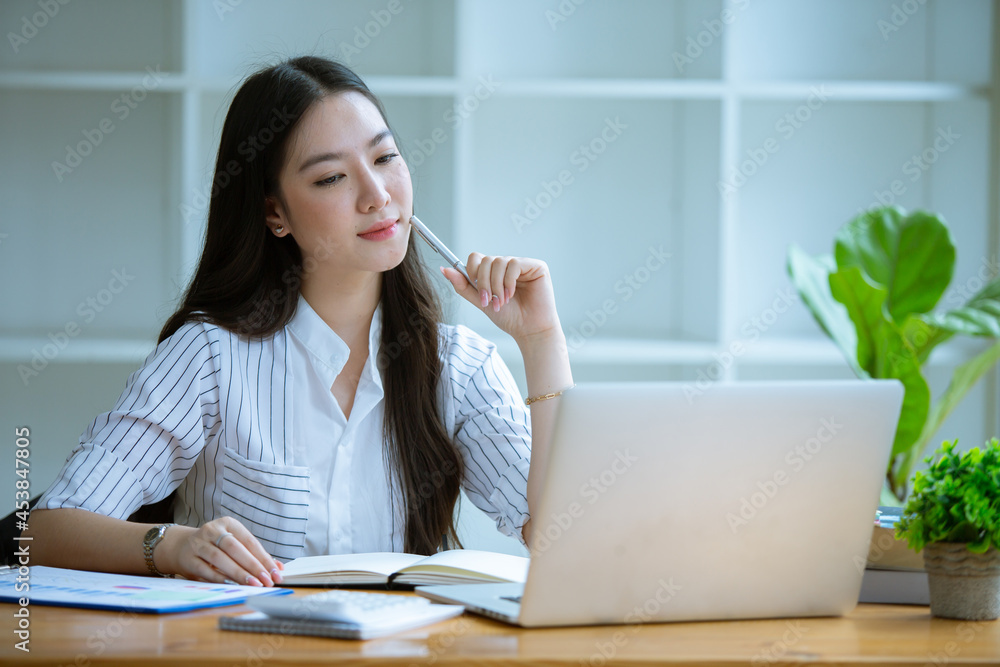 Portrait of Beautiful businesswoman sitting at desk and working with laptop computer. Portrait of Beautiful businesswoman sitting at desk and working with laptop computer.