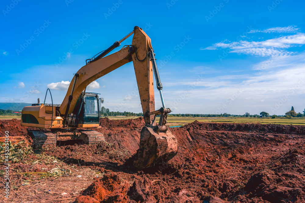 Backhoe or excavator working on land of countryside, excavator dig soil