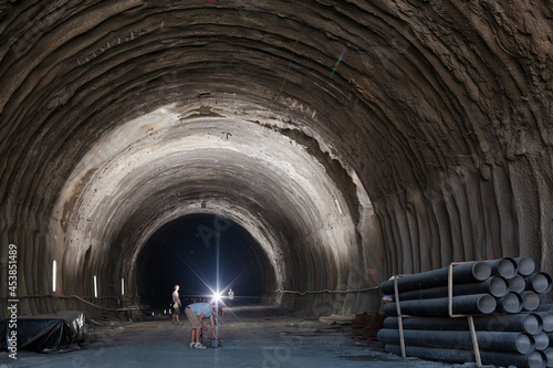 Business people reading blueprints in quarry