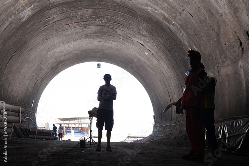 Businessmen reading blueprints in quarry