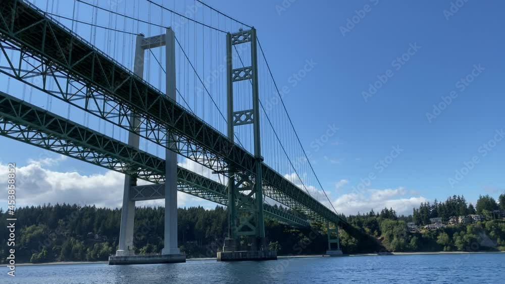 Sailing under the Western spans of the Tacoma Narrows Bridges on Puget Sound on the way to Gig Harbor shows off their beautiful architecture. Sailing under the Western spans of the Tacoma Narrows Bridges on Puget Sound on the way to Gig Harbor shows off their beautiful architecture.
