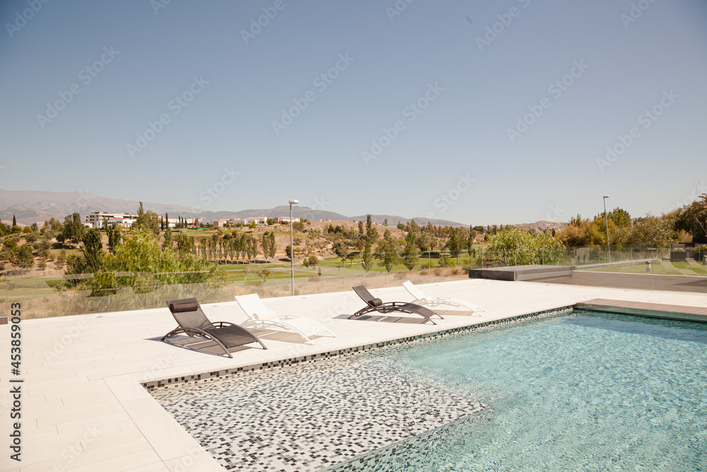 Swimming pool overlooking tree and mountains Swimming pool overlooking tree and mountains