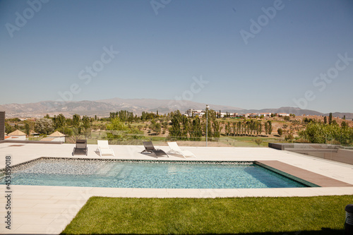 Swimming pool overlooking tree and mountains © KOTO