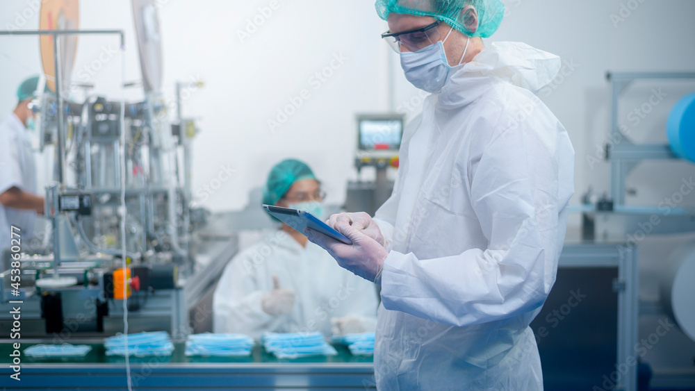 Workers producing surgical mask in modern factory, Covid-19 protection and medical concept. Workers producing surgical mask in modern factory, Covid-19 protection and medical concept.