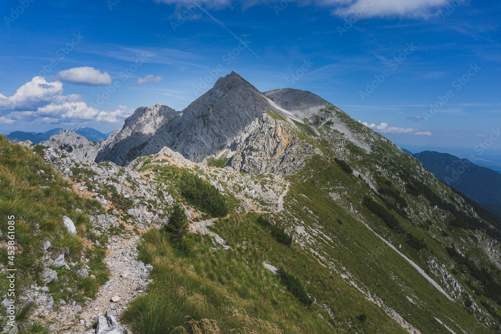 Beautiful mountain path. On the way to Mount Stol, Karawanken Mountains, Slovenia, Europe. Mountain lovers. Beauty of nature concept background. - obrazy, fototapety, plakaty 