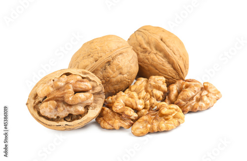 Pile of ripe walnuts on white background