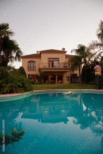 Luxury swimming pool and villa at dusk © KOTO