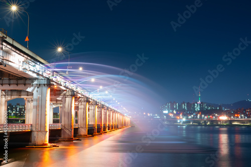 night and city scape travel and photography activity from banpo bridge is beautiful architecture and design during show fountain moving to people and traveler with reflection in river background