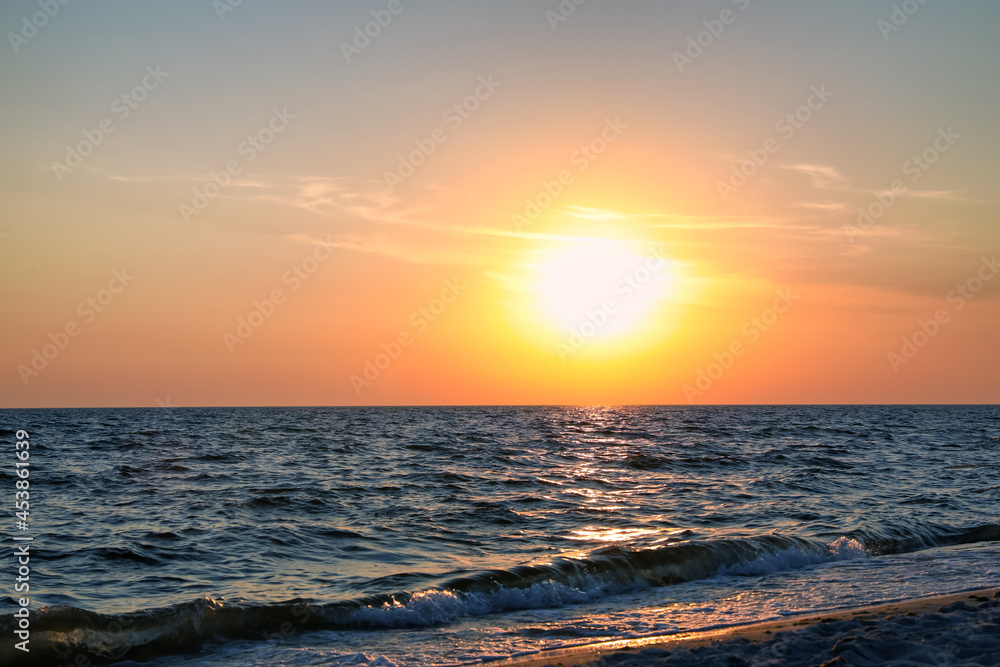 Beautiful sky with sun over sea at sunset