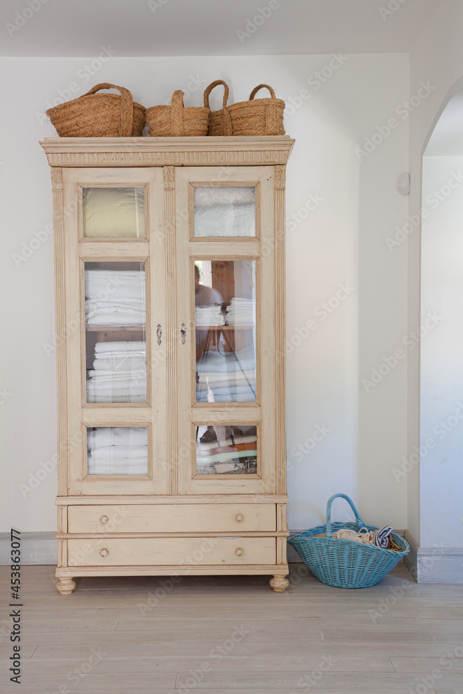Baskets around armoire Stock Photo Adobe Stock