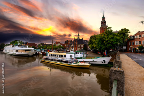 Leer, east frisia. View from Leda river on City Hall in Dutch Renaissance style , old Weigh House in Dutch classical Baroque style, Tourist Harbor and Bridge of Erich vom Bruch at sunset photo