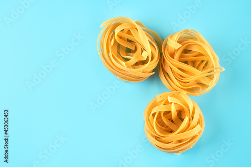 Pasta, macaroni, spaghetti isolated on blue background, flat lay, clipping path