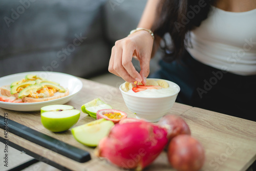 young Asian woman girl holding health food fresh vegetable in lifestyle at home  female beautiful vegetarian person doing diet nourishment eat salad meal  people are smile happy  healthy food concept