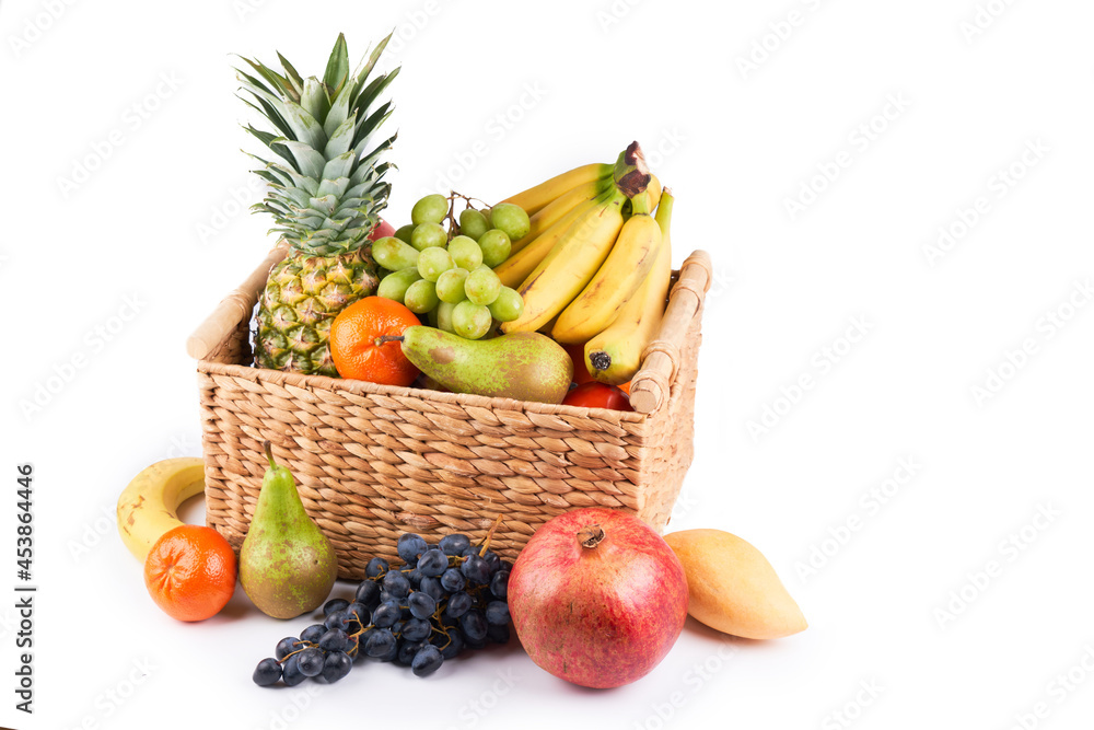 Mix variety of fresh juicy colorful exotic tropical fruits in basket on white background Mix variety of fresh juicy colorful exotic tropical fruits in basket on white background