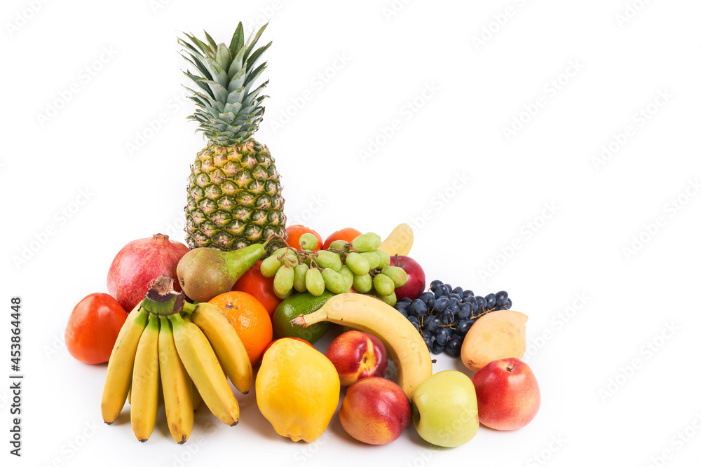 Mix of fresh juicy colorful exotic tropical fruits on white background