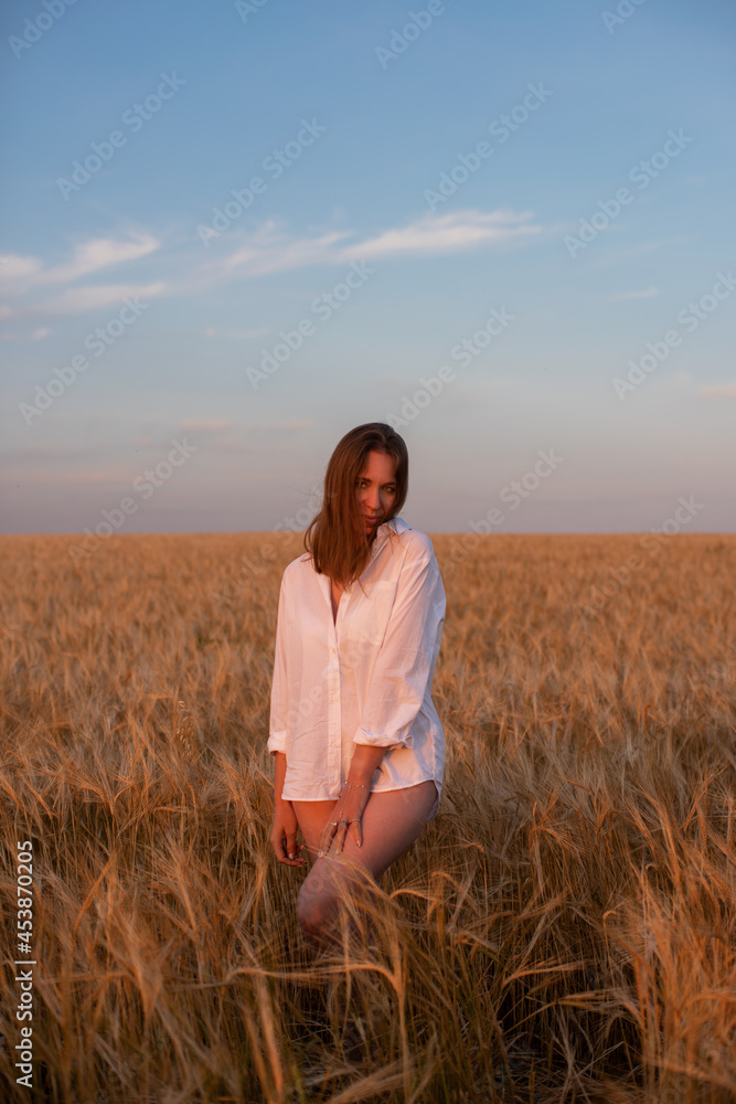 Aerial view of woman lying in the yellow field of wheat Aerial view of woman lying in the yellow field of wheat