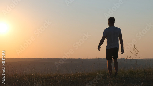 The man standing against the beautiful sunset