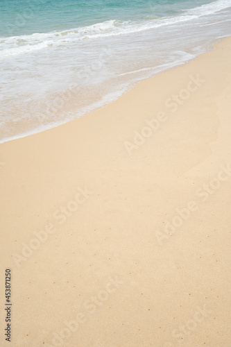Landscape waves nature splashes sand beach on sunlight.Blue wave and white foamy nature on sunny summer day.