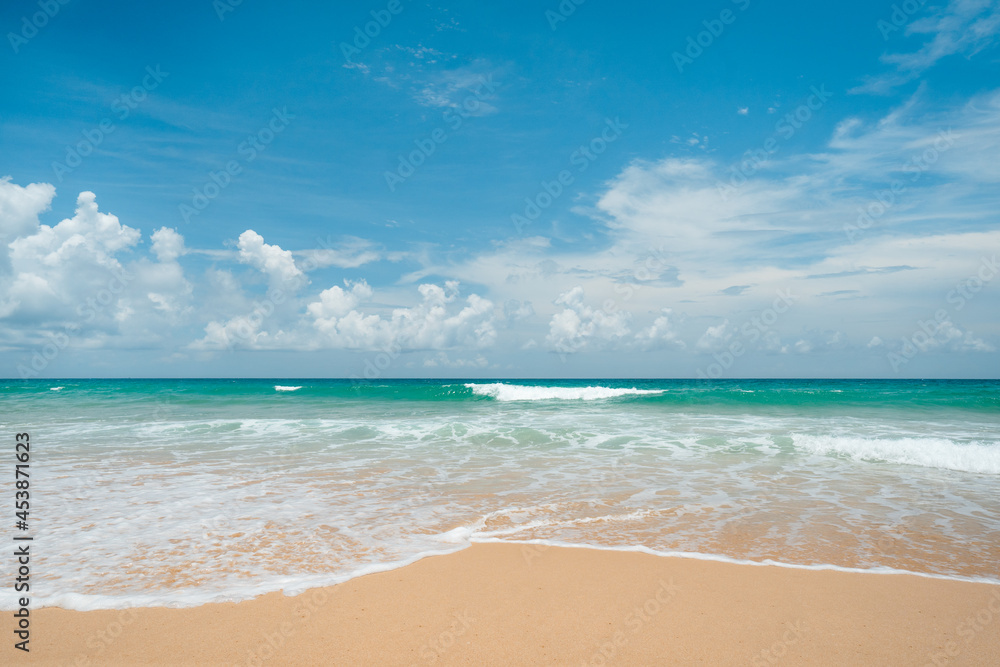 waves nature splashes sand beach on sunlight.blue sea and sky famous beach.